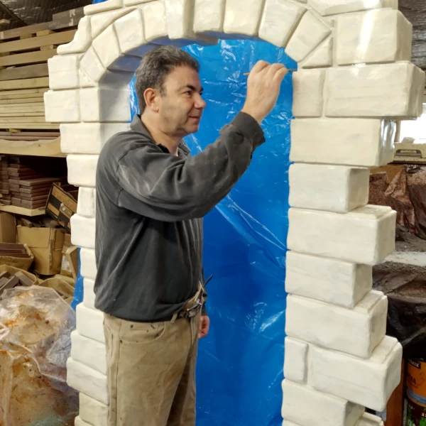 Me working on a wooden arch made to look like it's made from stone blocks.